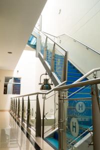 a staircase in a building with a blue and white wall at Hotel Sauces del Estadio in Medellín +28 photos