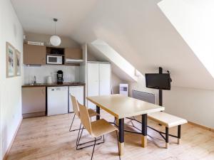 a kitchen and dining room with a table and chairs at Les Chalets d Ax N 303 - 2P4C in Ax-les-Thermes