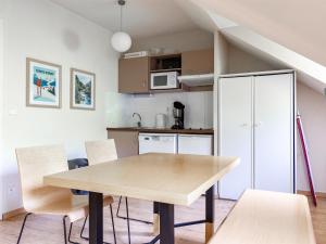 a kitchen and dining room with a wooden table and chairs at Les Chalets d Ax N 303 - 2P4C in Ax-les-Thermes +10 photos