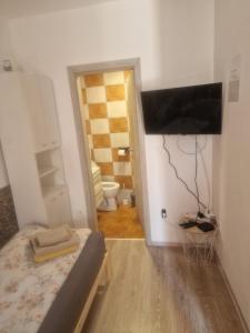 a small room with a bed and a bathroom at Apartma Alja Podkoren in Kranjska Gora