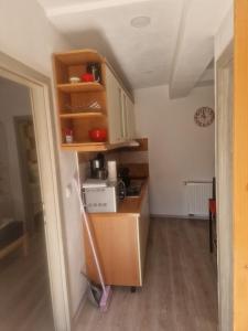 a small kitchen with a counter and a microwave at Apartma Alja Podkoren in Kranjska Gora
