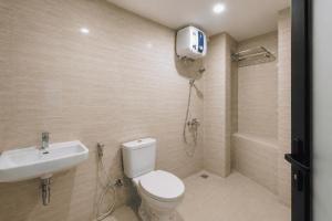 a bathroom with a toilet and a shower and a sink at Samara Villa by Sinergi in Tawangmangu