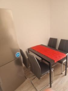 a dining room table with chairs and a red cloth on it at Apartma Alja Podkoren in Kranjska Gora