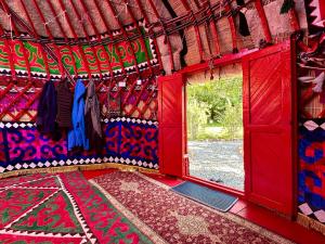 a room with a red door and a window at Nomad Garden Camp in Cholpon-Ata +15 photos