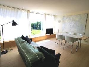 a living room with a couch and a table at Gîte du Mont Gérard in La Lanterne-et-les-Armonts