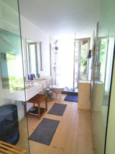 a bathroom with a tub and a sink and a mirror at Gîte du Mont Gérard in La Lanterne-et-les-Armonts +38 photos