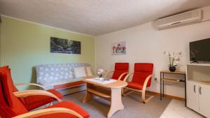 a living room with a couch and a table and chairs at Villa Rossy by Villas Guide in Pavicini