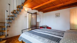 a bedroom with a bed in a room with wooden ceilings at Villa Rossy by Villas Guide in Pavicini +42 photos