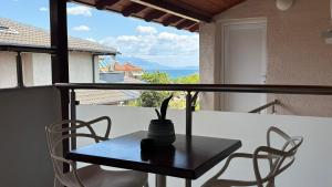 a table and chairs on a balcony with a view at Rodolithos Beach in Stavros