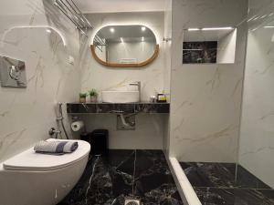 a bathroom with a toilet and a sink and a mirror at Rodolithos Beach in Stavros +68 photos
