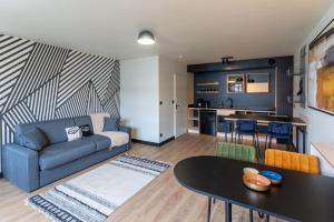 a living room with a couch and a table at Cowool Créteil in Créteil