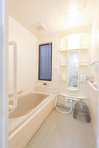 a white bathroom with a tub and a sink at お宿 しんみち in Nagoya +65 photos