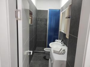 a bathroom with a white sink and a toilet at Eva & Resul apartments in Ilias