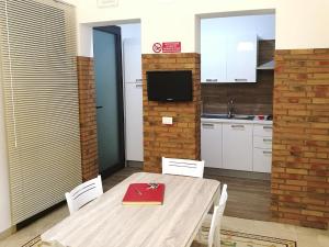 una cocina con una mesa con un libro rojo. en Primo Piano Riccio Locazione Turistica, en Trapani