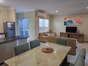 a living room with a table and a couch at Unit 66 Seafront Estate in Jurien Bay