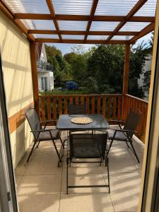 a patio with a table and chairs on a deck at Dom Gościnny Ania in Wisełka