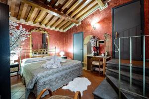 a bedroom with a bed in a room with red walls at Grand Hotel Panama Firenze in Florence