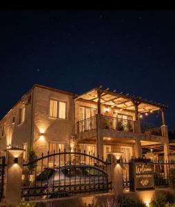 a large building with a balcony at night at Apartmani Vukotić in Budva