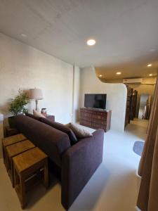 a living room with a couch and a tv at Sundown Lodge in San Fernando
