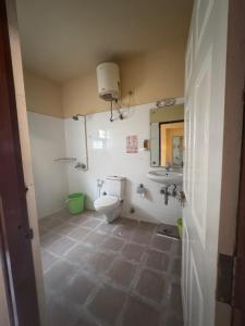 a bathroom with a toilet and a sink at Pravaha Hostel in Bangalore +21 photos