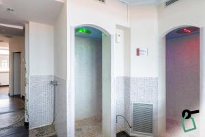 a bathroom with white walls and a walk in shower at HOTIDAY Room Collection - Alassio Centro in Alassio