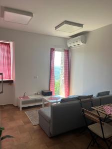 a living room with a couch and a table at Hramišče, Botega in Šmarje