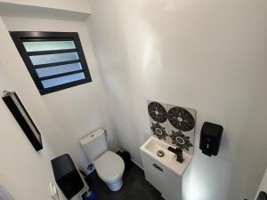 a small bathroom with a toilet and a window at Villa Papang in Saint-Paul +18 photos