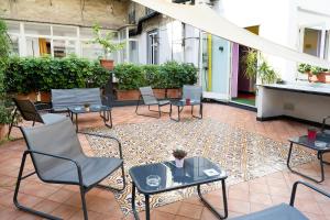 a patio with chairs and tables on a courtyard at Correra 241 Lifestyle Hotel in Naples