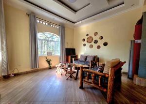 a living room with a couch and a table at Akagera Sunset House in Kabarondo