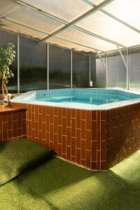 a hot tub in a building with red tiles at Chata u lesa in Prostřední Bečva