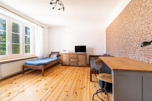 a living room with a couch and a table at Apartament dwupoziomowy in Dęblin
