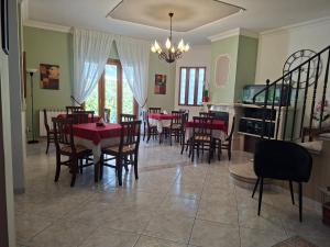 a dining room with tables and chairs and a chandelier at B&B TENUTA BIANCA in Oliveto Citra
