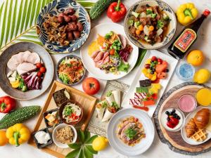 a table full of plates of food on a table at Hotel Resol Trinity Naha in Naha