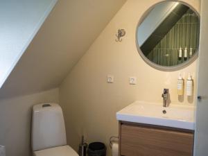 a bathroom with a sink and a mirror at Nørby Boutique Hotel in Fanø +23 photos