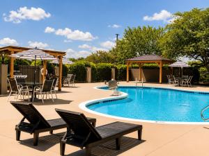 a pool with chairs and tables and umbrellas at Holiday Inn Johnson City by IHG in Johnson City