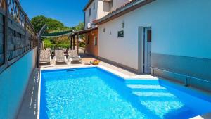 a swimming pool in the side of a building at Casa Aneri by Villas Guide in Pavicini