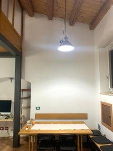 a room with a wooden table and a desk at Casa Mao in Noto