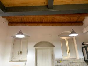a kitchen with three lights hanging from the ceiling at Casa Mao in Noto