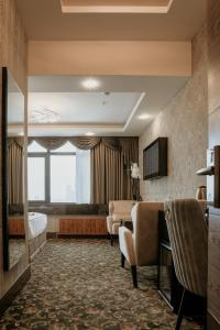 a hotel room with a bed and a couch at Otel Grand Lark İstanbul in Istanbul