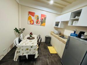 a small kitchen with a table and a refrigerator at The Uptown deluXE Studio #5 in Balulang +3 photos