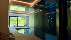 a hallway with a glass door leading to a pool at Pensiunea Amonte in Avrig