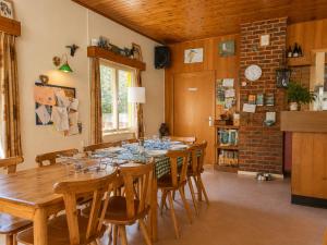 a dining room with a long table and chairs at Camping La Lienne in Stoumont
