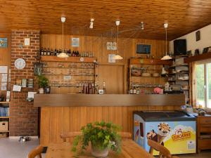 a restaurant with a table and a counter in a room at Camping La Lienne in Stoumont