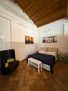 a bedroom with a bed and a chair in it at Villa Clementine in Piazza Armerina +84 photos