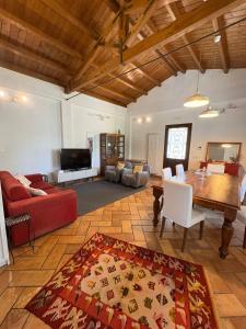 a living room with a table and a couch at Villa Clementine in Piazza Armerina