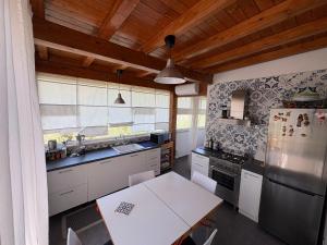 a kitchen with white appliances and a wooden ceiling at Villa Clementine in Piazza Armerina