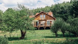 a house on a hill with trees in front of it at Gite De La Mortagne in Mortagne