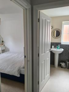 a bedroom with a bed and a sink at FV Dwelling in Nottingham