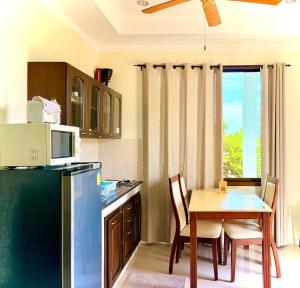 a small kitchen with a table and a microwave at Viking House Apartment in Ko Tao