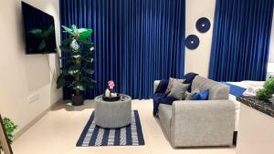 a living room with a couch and a table at Navy Studio By Bait Zain in As Sīfah